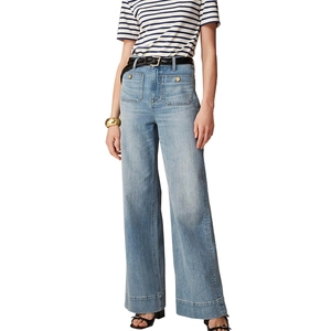 Detail of high waisted wide leg jeans with light blue wash and front buttoned patch pockets