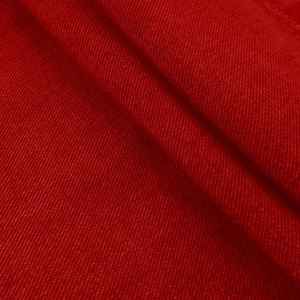Detailed macro view of the premium red twill denim fabric texture and thick cotton weave