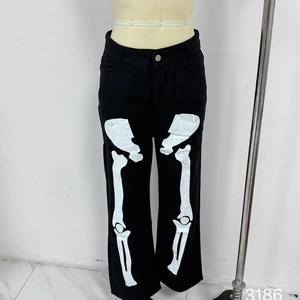 Detail of street-style black wide-leg trousers featuring white bone prints on human mannequin