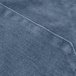 Macro view of blue denim fabric texture and precise single stitching on these women's shorts