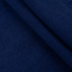 Macro shot of dark blue denim fabric texture and diagonal twill weave pattern detail
