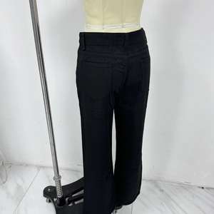 Detailed back view of black casual trousers showing symmetrical pockets and cotton texture