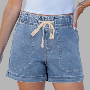 Detail of light blue denim shorts featuring elastic drawstring waist and large front pockets
