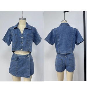 Macro detail of blue washed denim shirt and skort set with metal buttons and pockets