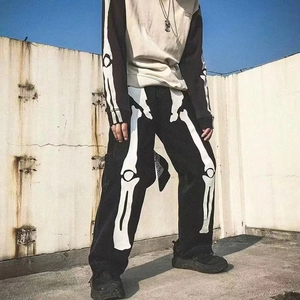 Detailed view of luminous bone print on street-style baggy black straight denim pants