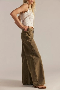 Detailed side view of high-waisted brown wide-leg trousers with visible vertical seams