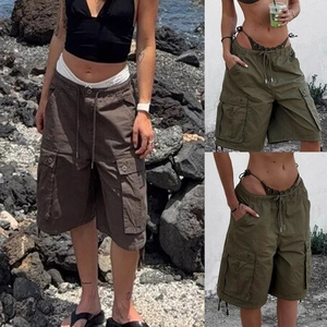 Detail view of khaki and olive cargo shorts with functional pockets and drawstring waist