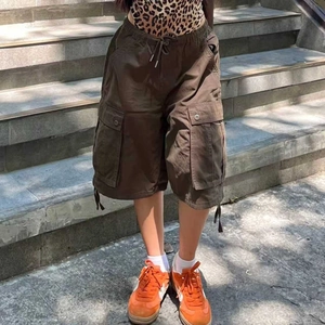 Detail view of dark brown cargo shorts showing drawstring waist and large side pockets