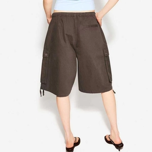 Detail of dark brown cargo shorts featuring rear pocket and adjustable drawstring cuffs