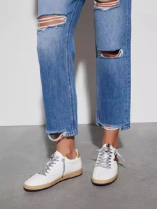 Women's white low-top sneakers with a dark star detail and silver sequin laces