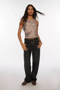 Detail of high-waist washed black wide-leg denim jeans styled with a black leather belt