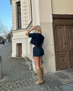 Rear view of deep blue denim two-piece set featuring short-sleeved top and high-waist shorts