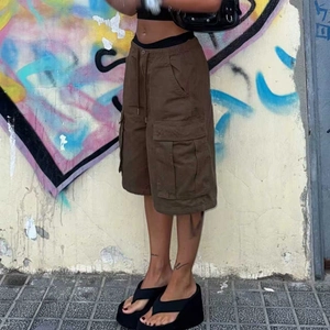 Detail of brown cargo shorts showing large utility pockets and adjustable drawstring waist