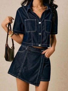 Detail of navy blue denim set with contrast white stitching and metal buttons