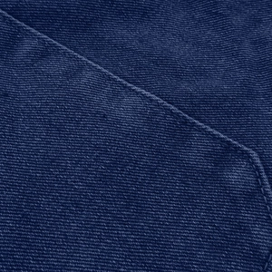 Detailed macro view of dark blue denim fabric texture and high-quality single stitching