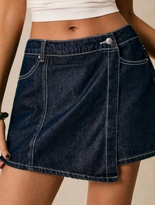 Detail of dark blue wrap-around denim skirt with contrast stitching and metal buckle