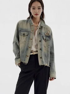 Vintage light blue distressed denim jacket with a cropped fit and frayed hem for women