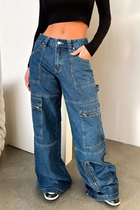 Detail view of high-waist cargo jeans featuring multiple zipper pockets and wide-leg cut