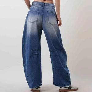 Detail of high-waist vintage blue wide-leg jeans showing back pockets and washed texture