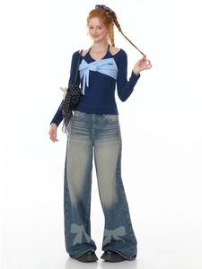 Women vintage wide-leg jeans with bow print and navy knit top in balletcore style