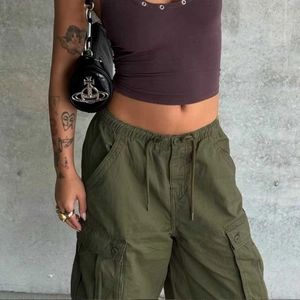 Close-up of olive green cargo shorts featuring drawstring waist and signature side pockets