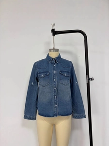 Classic mid-blue wash denim shirt for women with dual chest pockets and metal buttons