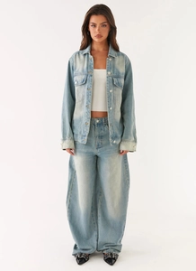 Full body view of vintage light blue washed denim jacket and straight jeans outfit