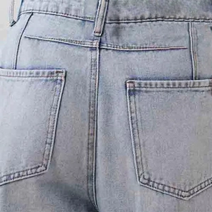 Detail of light blue denim jeans showing rear pockets and reinforced stitching