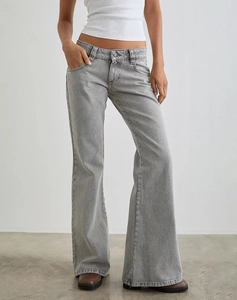 Detail of high waisted slim fit flared jeans in light grey with minimalist styling