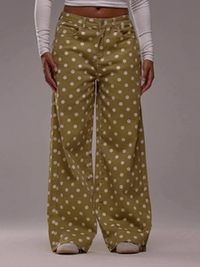Detailed shot of olive green wide-leg denim jeans with white polka dots and high waist