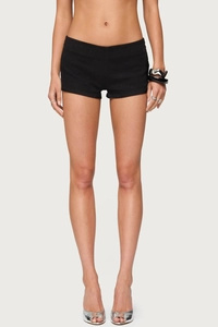 Detailed view of women's black low-rise denim shorts with stretch slim fit design