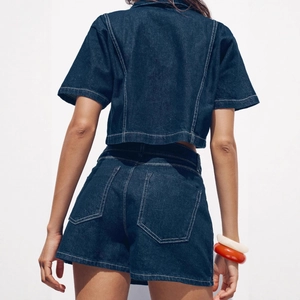 Back view of a stylish dark blue denim two-piece set with a cropped top and high-waist shorts