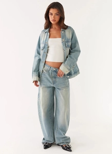 Full body view of a washed blue denim jacket set with wide leg jeans and white tube top