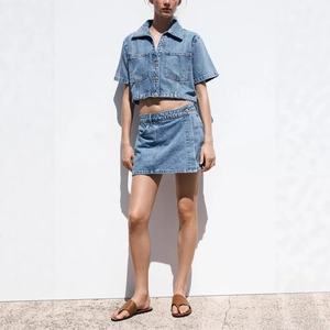 Two-piece light blue denim set with short sleeve utility shirt and mini skirt for women