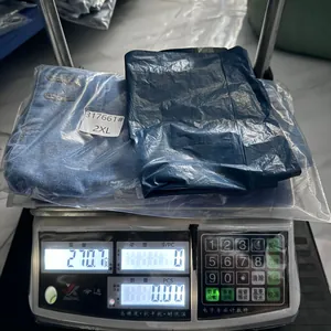 Light blue ripped denim shorts size 2XL weighing 210g on a digital scale in warehouse