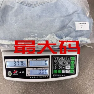 Blue denim shorts showing size L tag and weight measurement on digital scale