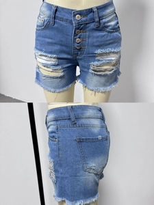 Detail view of light blue distressed denim shorts with button fly and frayed hem