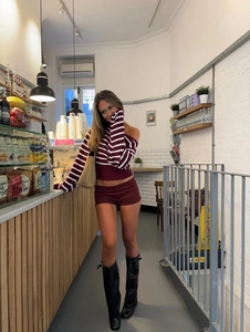 Detail of red and white striped off-shoulder top and burgundy slim fit shorts set