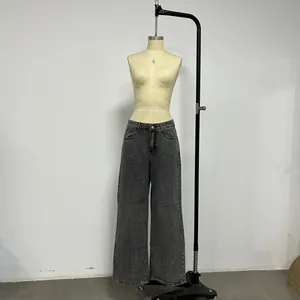 Detail view of washed smoke gray tencel denim trousers with a retro faded texture