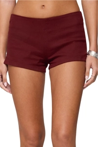 Close-up of wine red slim-fit denim shorts featuring stretch fabric and high waist design