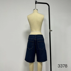 Rear view of loose fit dark blue denim shorts with classic double patch pockets