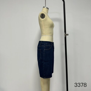 Detail view of deep blue denim shorts featuring premium stitching and classic five-pocket design