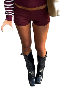 Detailed look at slim fit burgundy denim shorts paired with black square toe leather boots