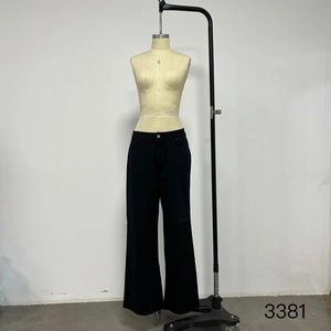 Detail of high-waisted black wide-leg tencel denim jeans with pockets on a mannequin