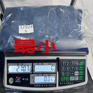 Slim fit denim shorts in blue showing product weight on scale for shipping details