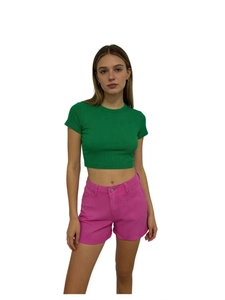 High-waist retro denim shorts in hot pink paired with a green slim-fit crop top shirt