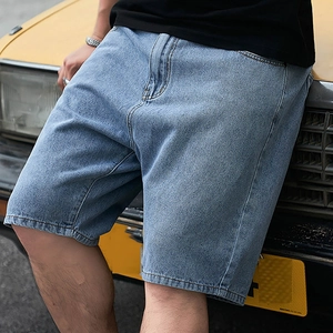 Detailed view of light blue denim shorts styled with a vintage yellow car background