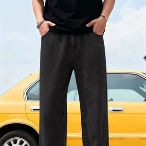 Men's relaxed fit black tencel denim jeans shown in a lifestyle outdoor setting