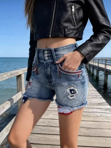 High-waist American flag denim shorts with three buttons and frayed edges for women
