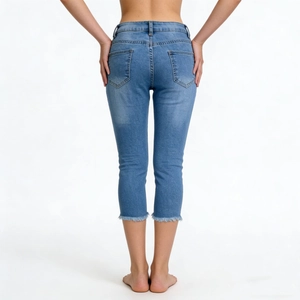 Slim fit light blue denim cropped pants with frayed hems and back pocket details